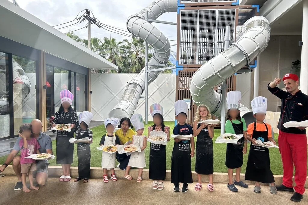 Hyatt Regency Phuket with Kids – My Honest Review 6 A group of kids wearing chef hats and holding pizza.