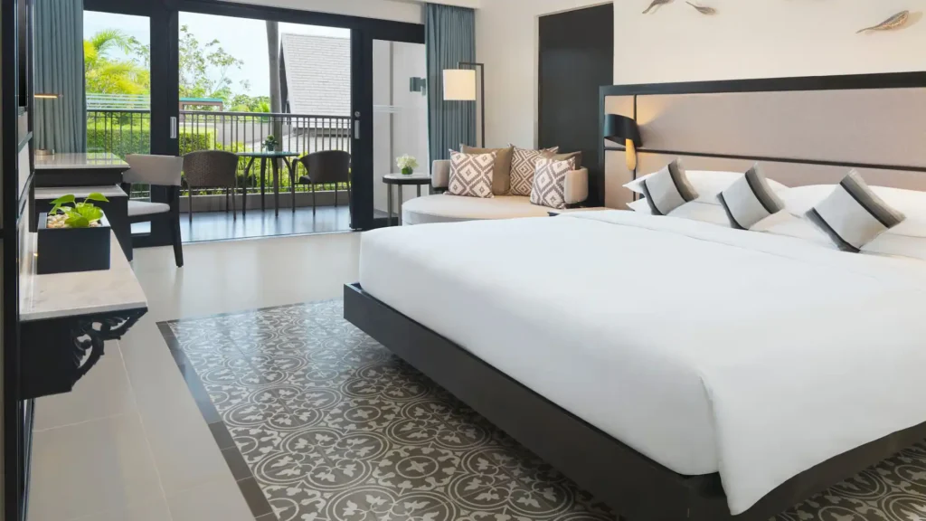 Hyatt Regency Phuket with Kids – My Honest Review 1 A bedroom with a bed and a couch. Hyatt Regency Phuket with Kids.