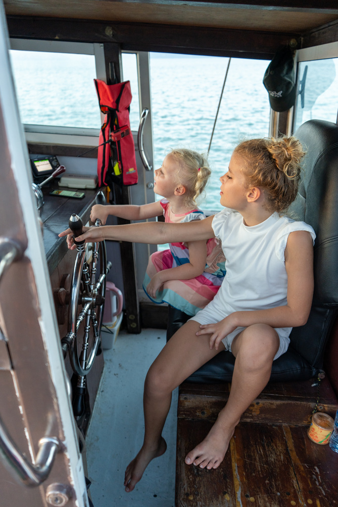 Two girls sitting on a boat.