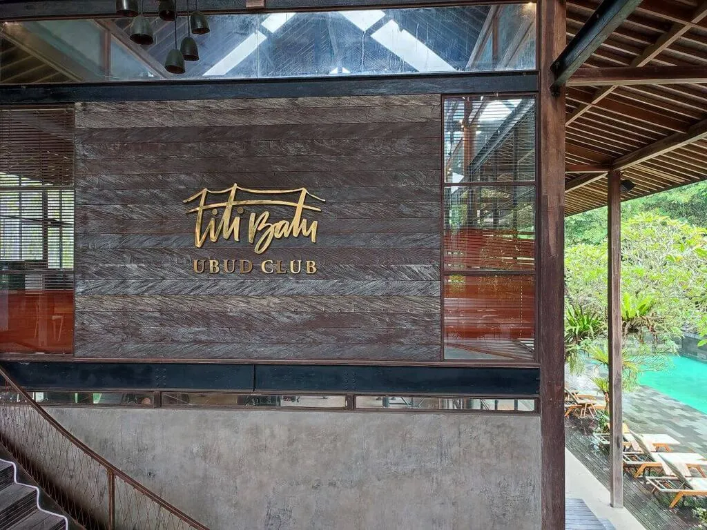Bali Family Guide – Top 8 Things to do in Ubud with Kids 5 A golden sign on a wall saying "Titi Batu Ubud Club".