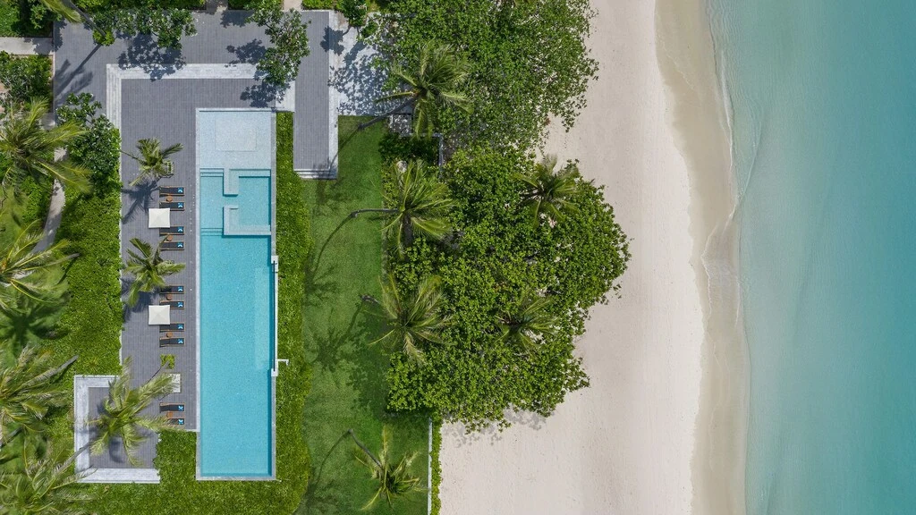 A pool and trees on a beach.