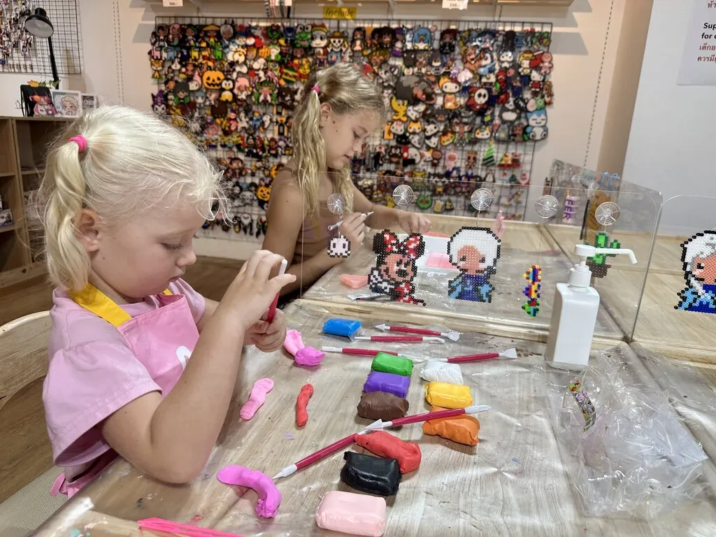 Two young girls playing with play dough.