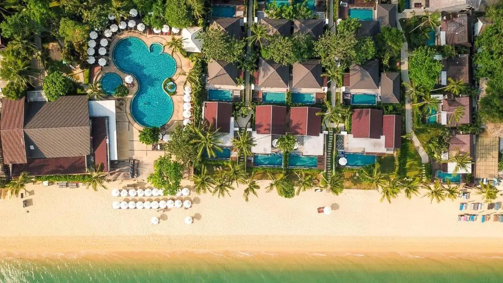 An aerial view of a swimming pool and a beach.
