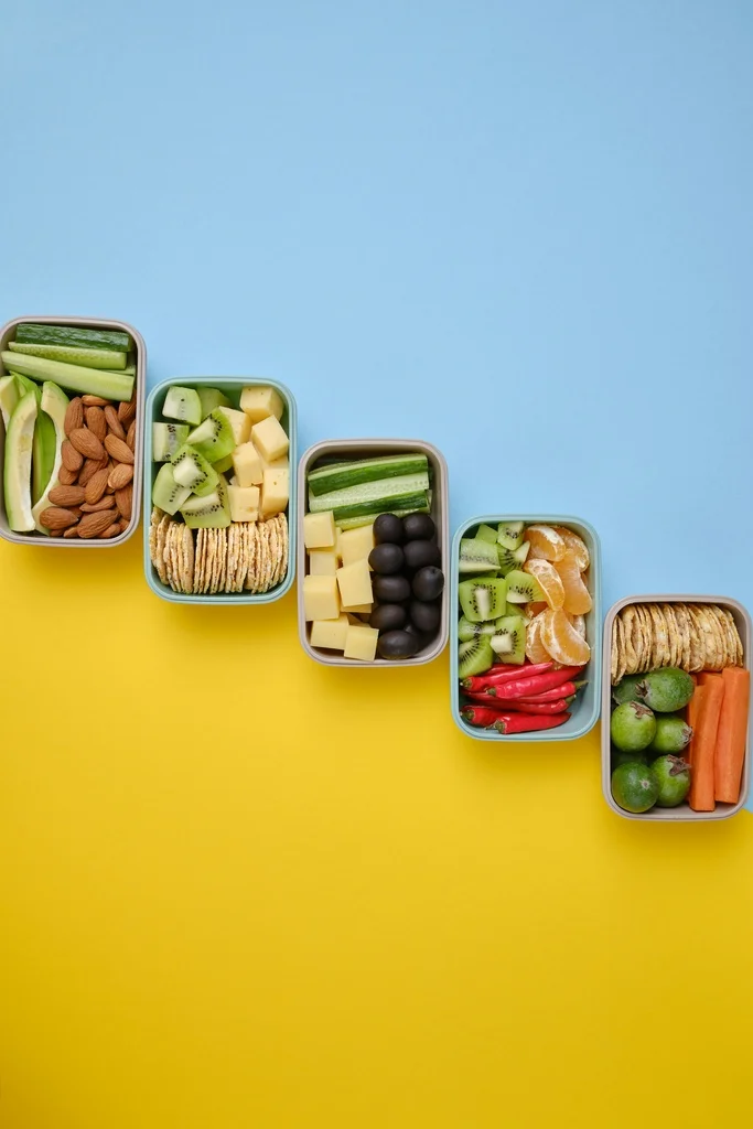 40 Best Family Travel Tips from Digital Nomad Parents 16 A group of containers with food in them.