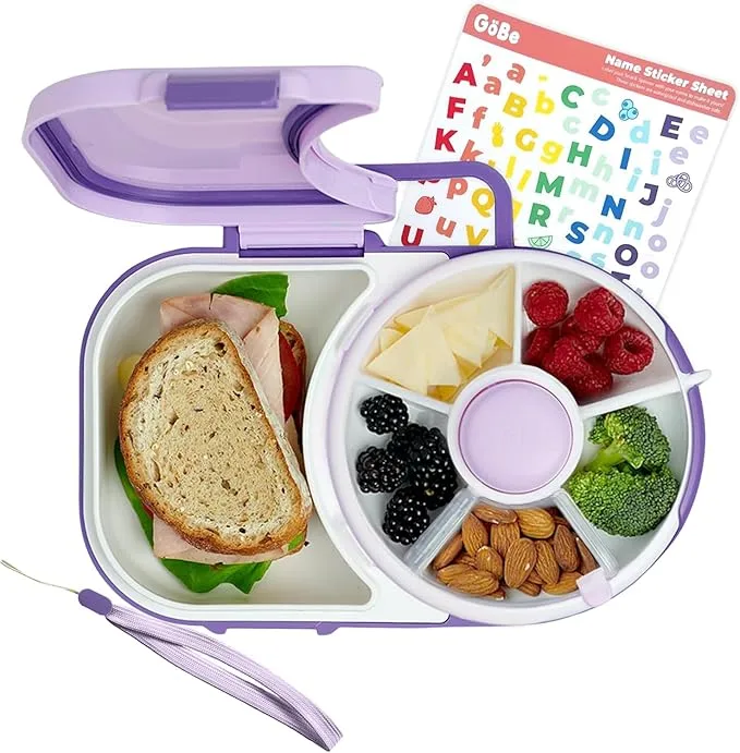 A purple lunch box with a sandwich and fruit.
