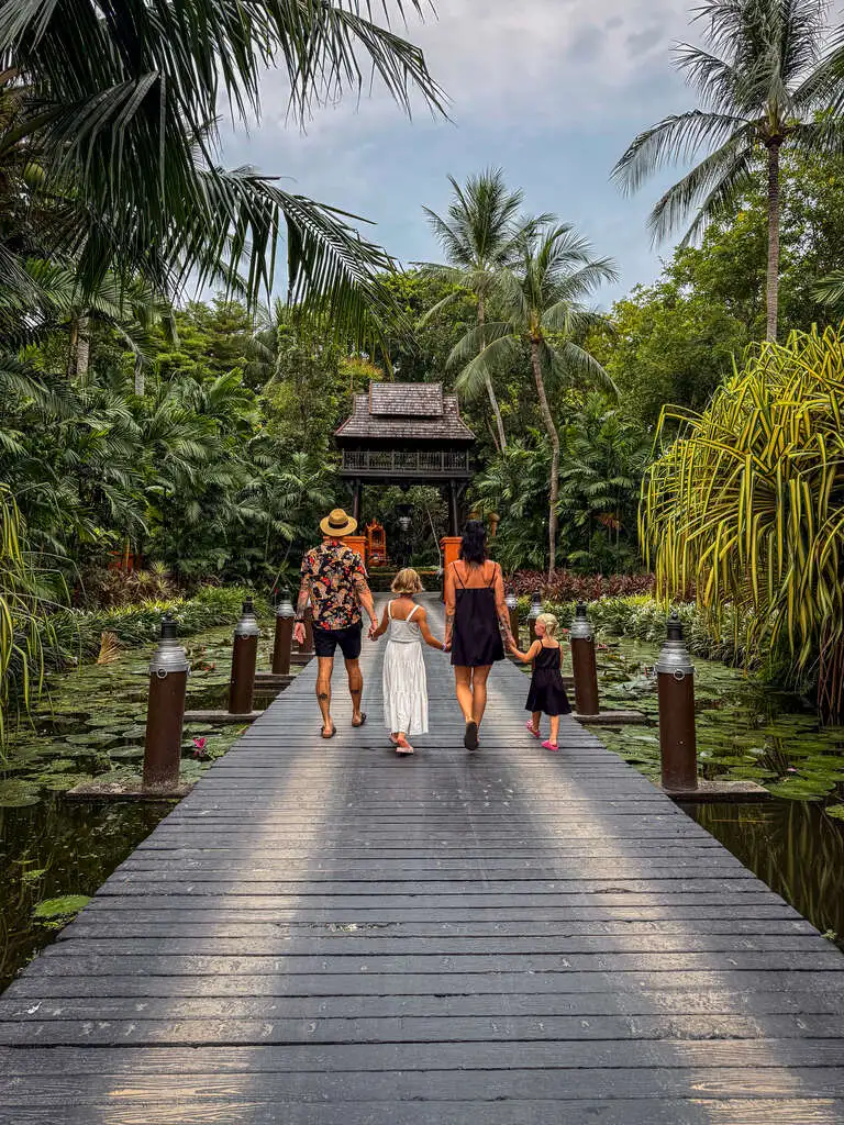 Anantara Bophut Koh Samui – Honest Family Review 2025 2 A group of people walking on a wooden bridge.