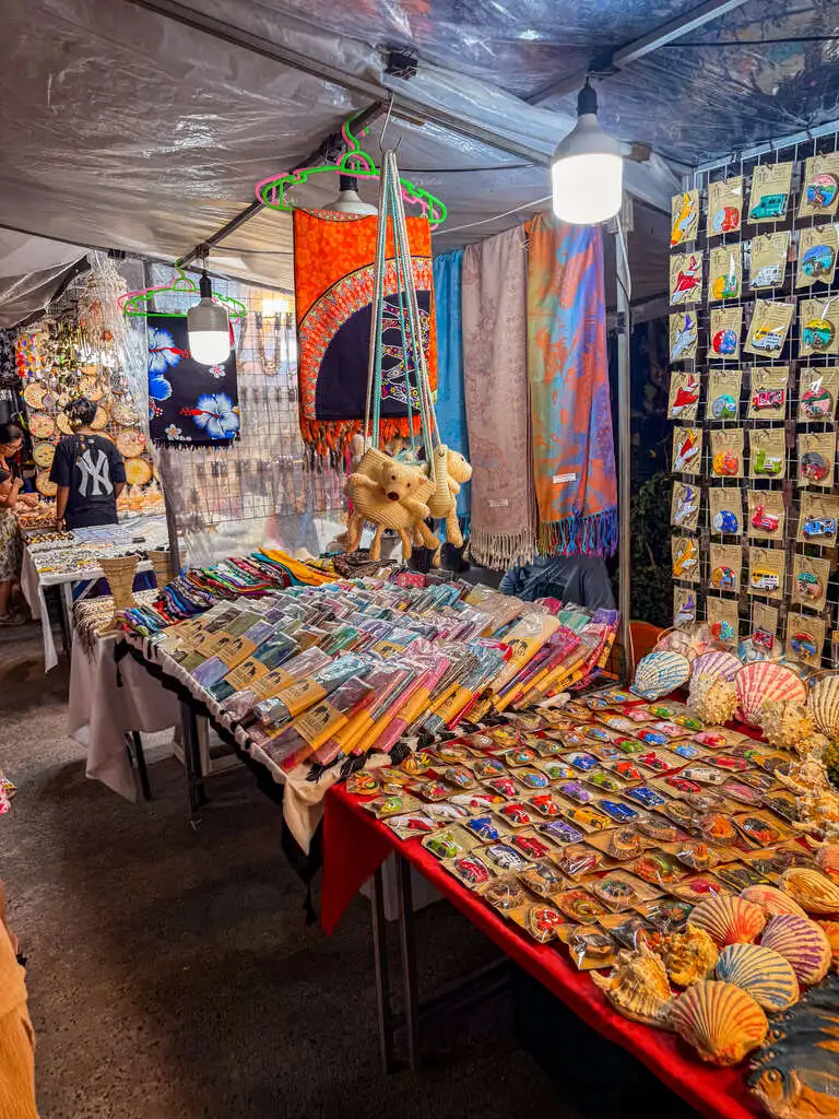 A table on a night market with items on it.