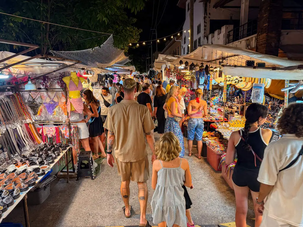 Koh Samui with Kids: 25 Super Fun Things to Do in 2025 4 A group of people walking in a street market.