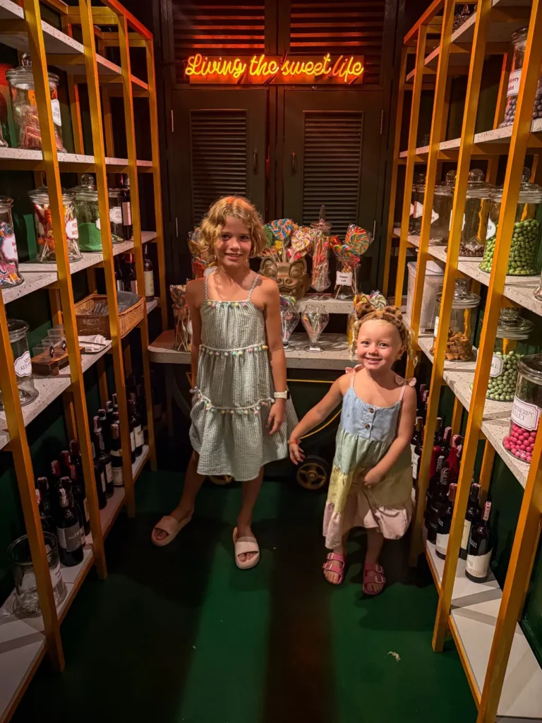 Anantara Bophut Koh Samui – Honest Family Review 2025 27 Two girls standing in a room with shelves full of candy.
