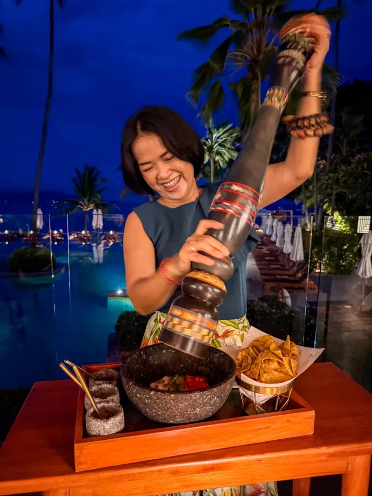 Anantara Bophut Koh Samui – Honest Family Review 2025 25 A woman pouring food into a bowl.