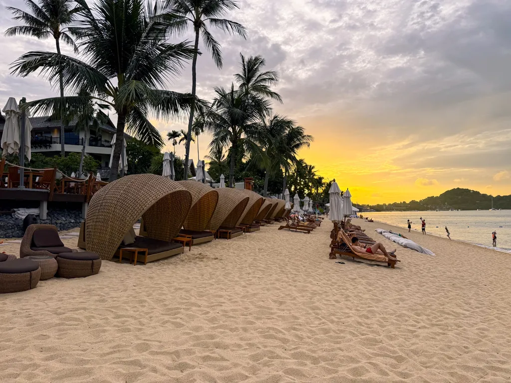 Anantara Bophut Koh Samui – Honest Family Review 2025 21 A beach with chairs and umbrellas.