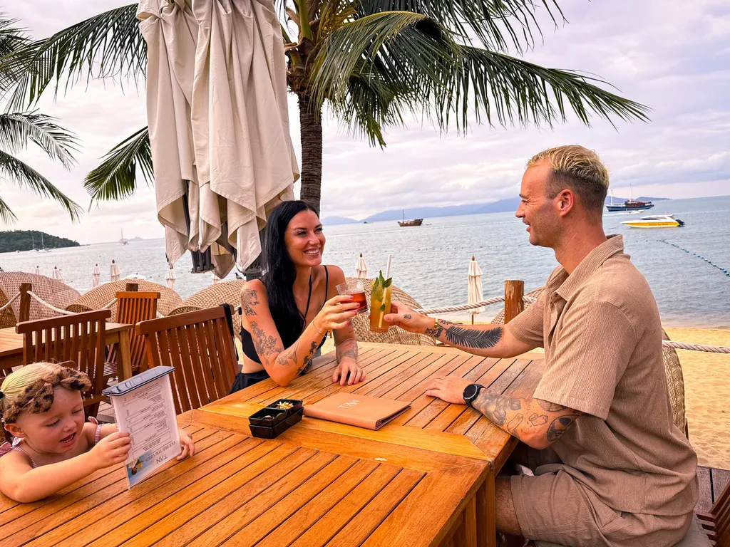 Anantara Bophut Koh Samui – Honest Family Review 2025 20 A man and woman sitting at a table with drinks.