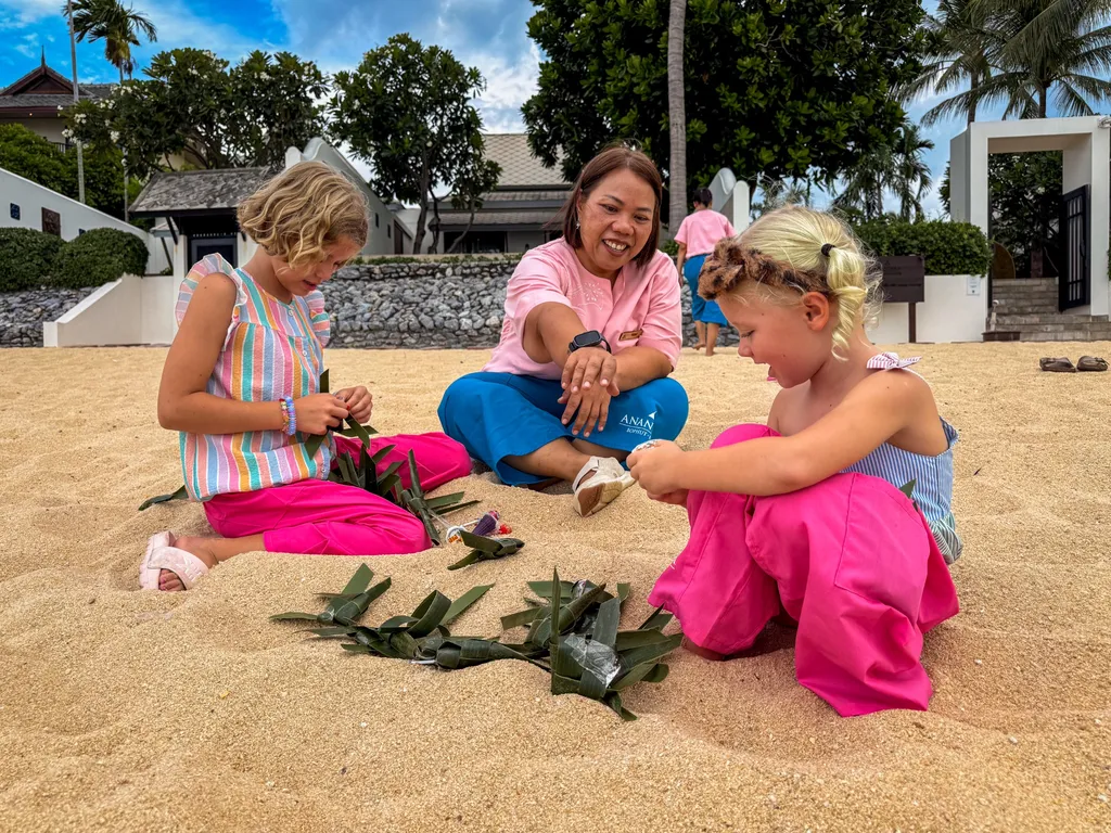 Anantara Bophut Koh Samui – Honest Family Review 2025 18 A group of people sitting on sand.