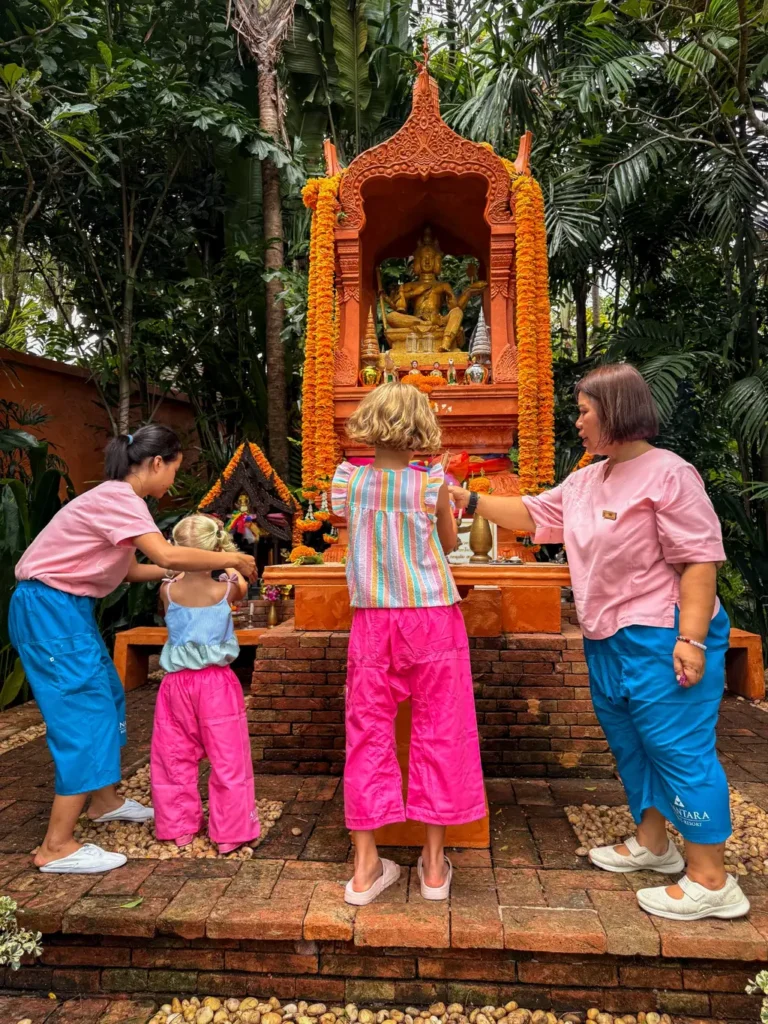 Anantara Bophut Koh Samui – Honest Family Review 2025 17 A group of people standing in front of a statue.