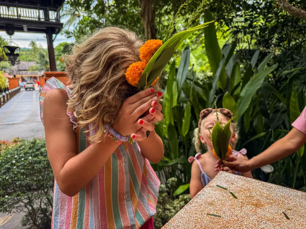 Anantara Bophut Koh Samui – Honest Family Review 2025 16 A girl holding flowers in front of another girl.