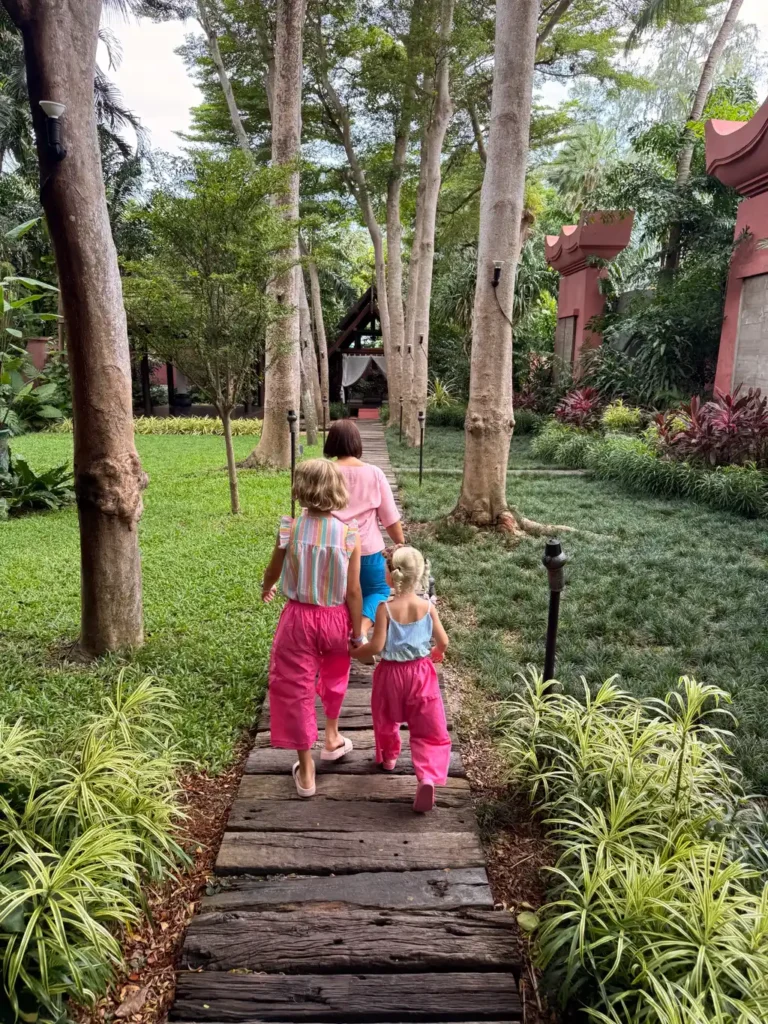 Anantara Bophut Koh Samui – Honest Family Review 2025 14 A group of people walking on a path in a garden.