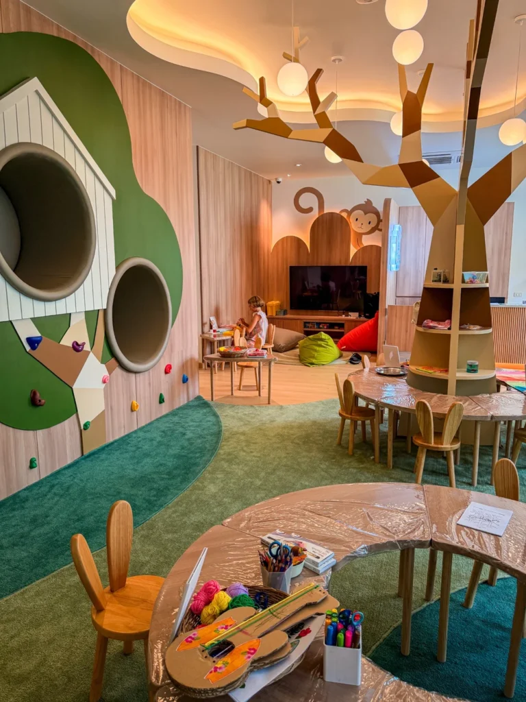 Anantara Bophut Koh Samui – Honest Family Review 2025 11 A room with a tree and a kid sitting on it.