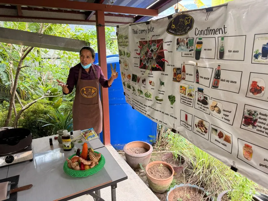 Koh Samui with Kids: 25 Super Fun Things to Do in 2025 14 Thai Woman in an outdoor kitchen teaching cooking.