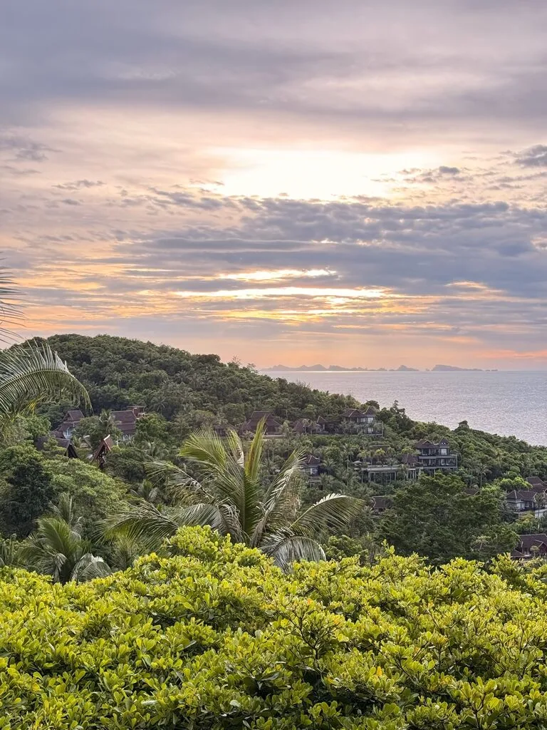 Green tropical mountain with cloudy sunset in the background. June is one of the best time to visit Koh Samui.