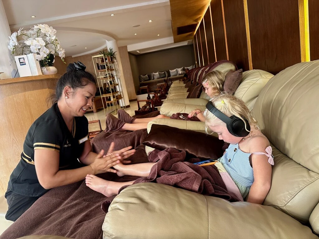 Koh Samui with Kids: 25 Super Fun Things to Do in 2025 30 A woman giving a girl a foot massage.