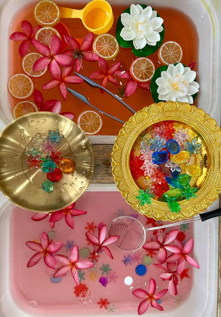 Top 10 Indoor Playgrounds in Koh Samui – Rainy Day Tips 4 A tray of water with flowers and fruit at Kidomo, one of the best Indoor Playgrounds in Koh Samui.