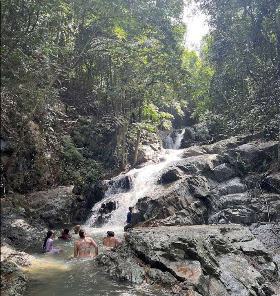 20 Top Things to Do in Koh Samui – My 2025 Highlights 7 People bathing in the pool of a waterfall in a jungle setting.