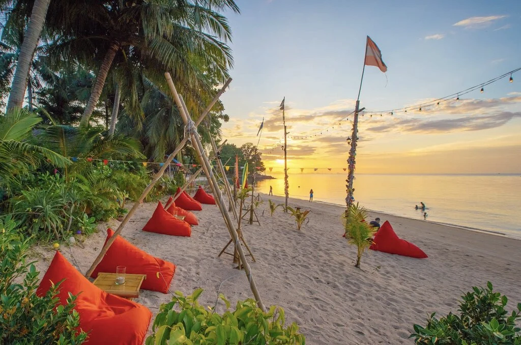 Koh Samui with Kids: 25 Super Fun Things to Do in 2025 12 Beach with trees and orange bean bags.