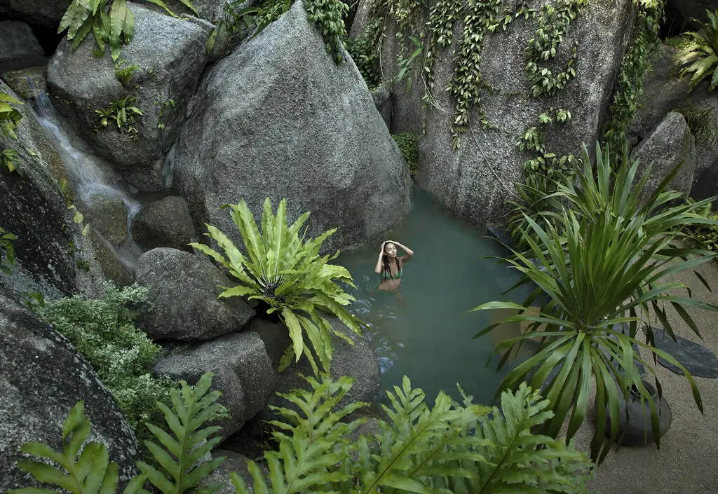 20 Top Things to Do in Koh Samui – My 2025 Highlights 23 Woman bathing in natural pool surrounded by greenery.