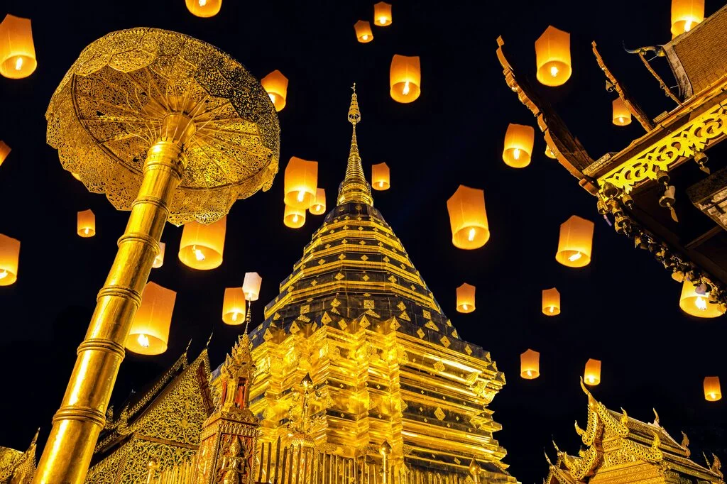 A building with lanterns flying in the sky.