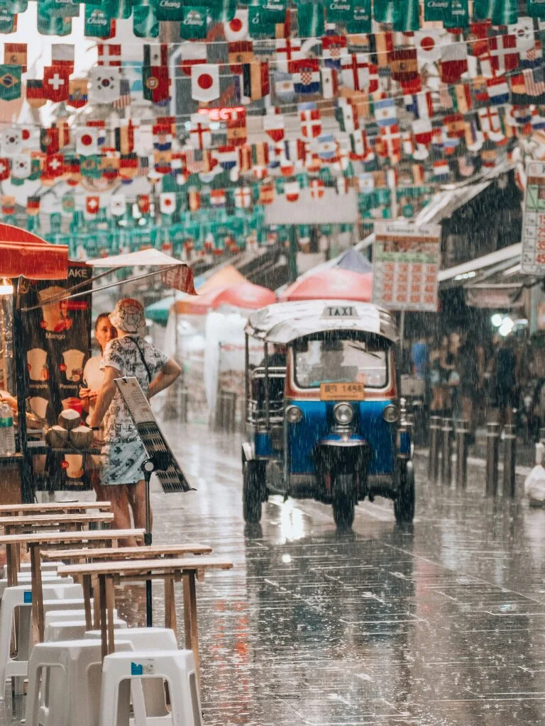 Rainy Season in Thailand – All You Need to Know 2 People walking in the rain.