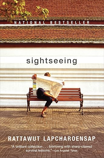 A person sitting on a bench reading a map.