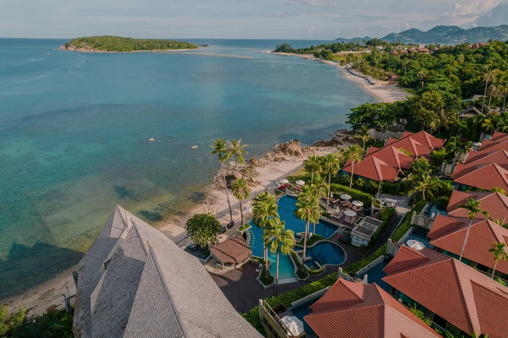 A beach with houses and a pool in Koh Samui.