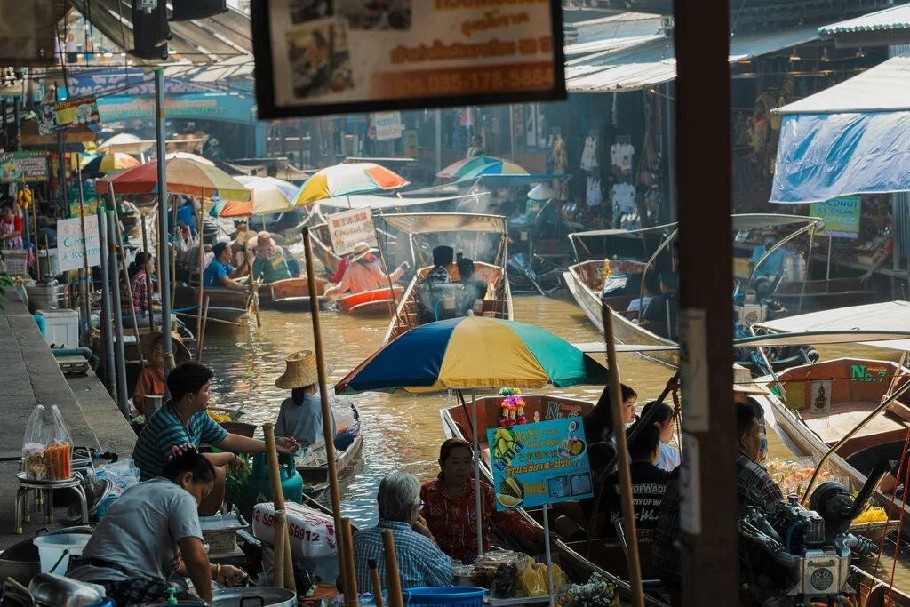 A group of people in boats in a canal.