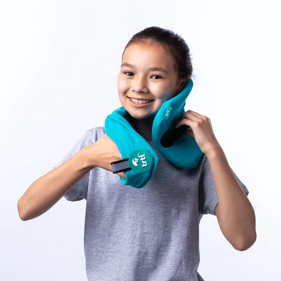The 5 Best Travel Pillows for Kids in 2025 3 A girl wearing a blue neck pillow.