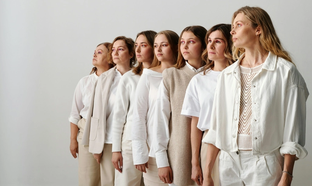 Big family lining up in a white studio background.
