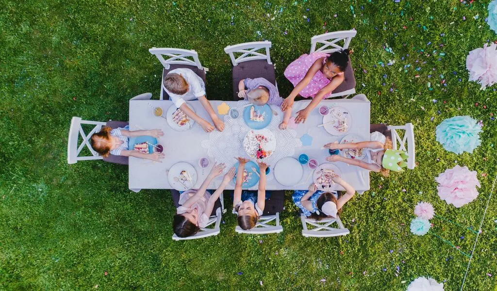 Kids sitting on a table.