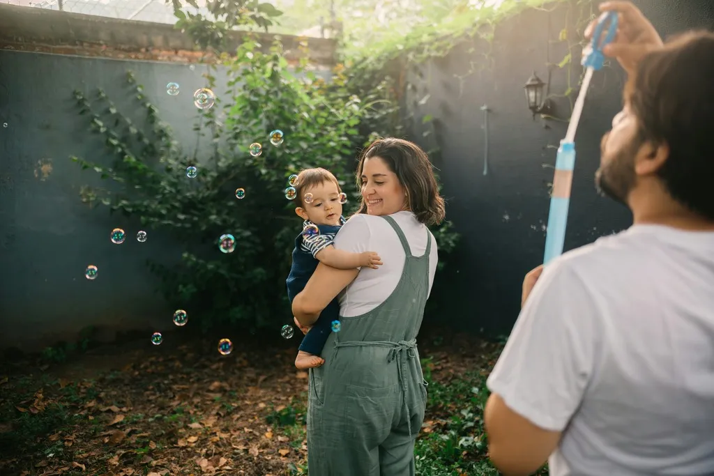 Family in a garden playing with bubbles.