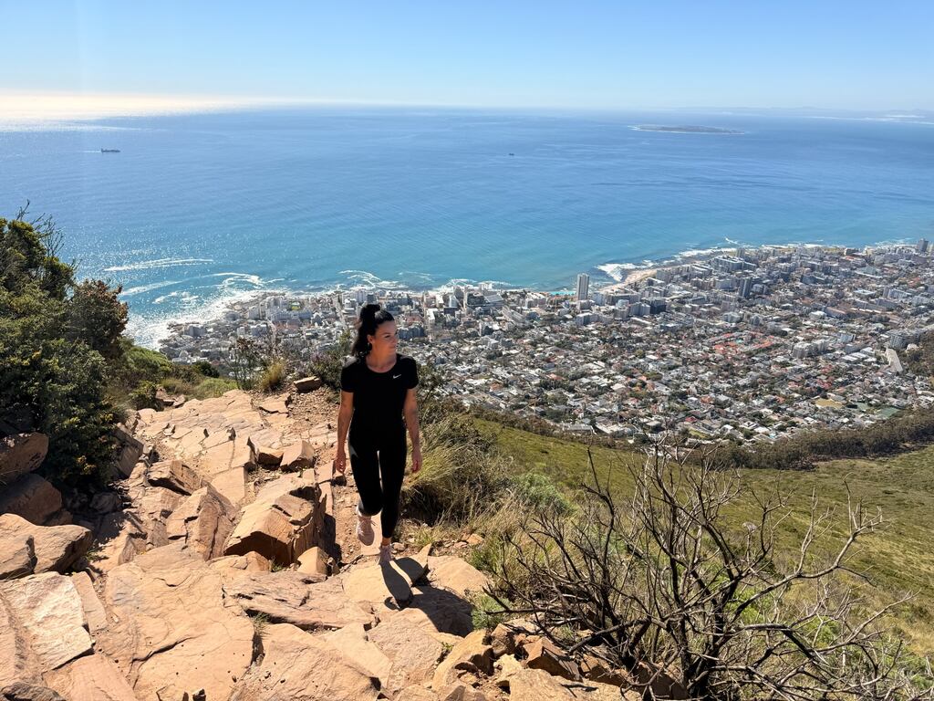 Hiker overlooking Cape Town coastline.