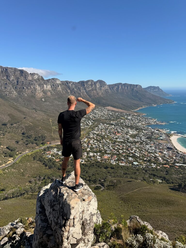 Person overlooking scenic coastal landscape.