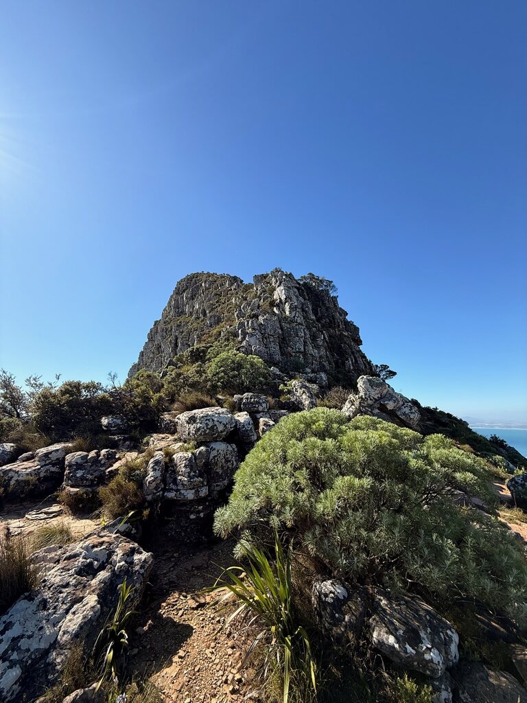 Rocky mountain under clear blue sky.