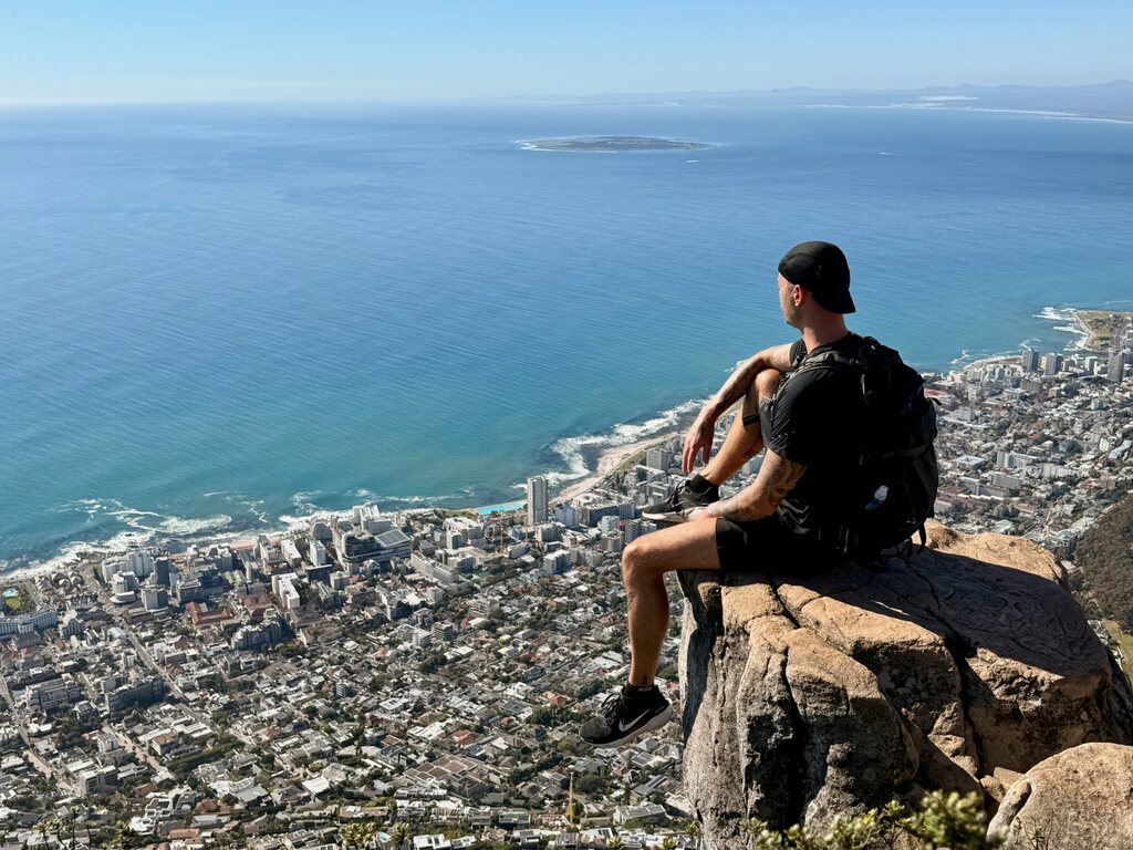 Hiker overlooking Cape Town coastline.