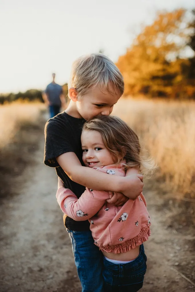 Boy hugging a girl.