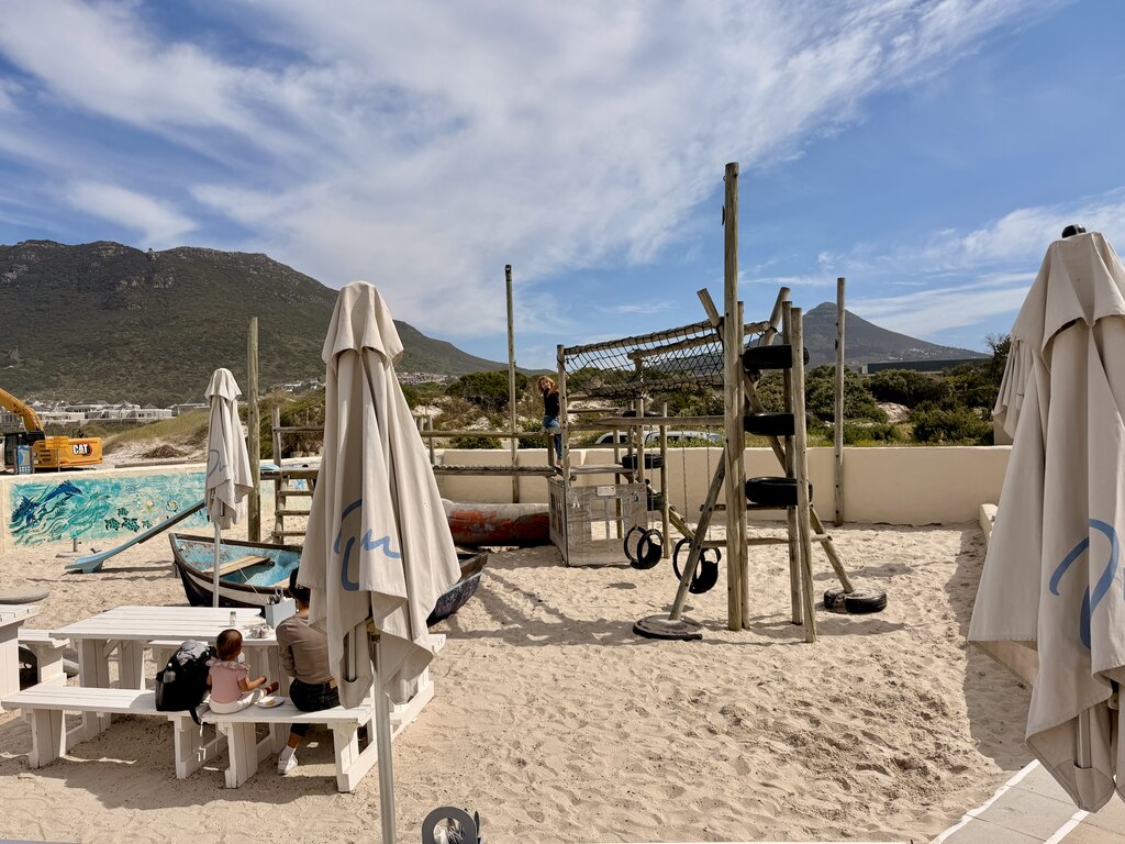 Beach playground with mountain backdrop.