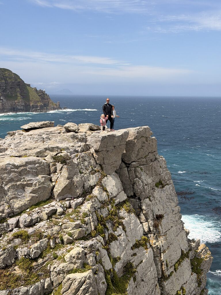 Cape of Good Hope Day Trip – Family Fun in South Africa 14 Couple standing on rocky cliff.