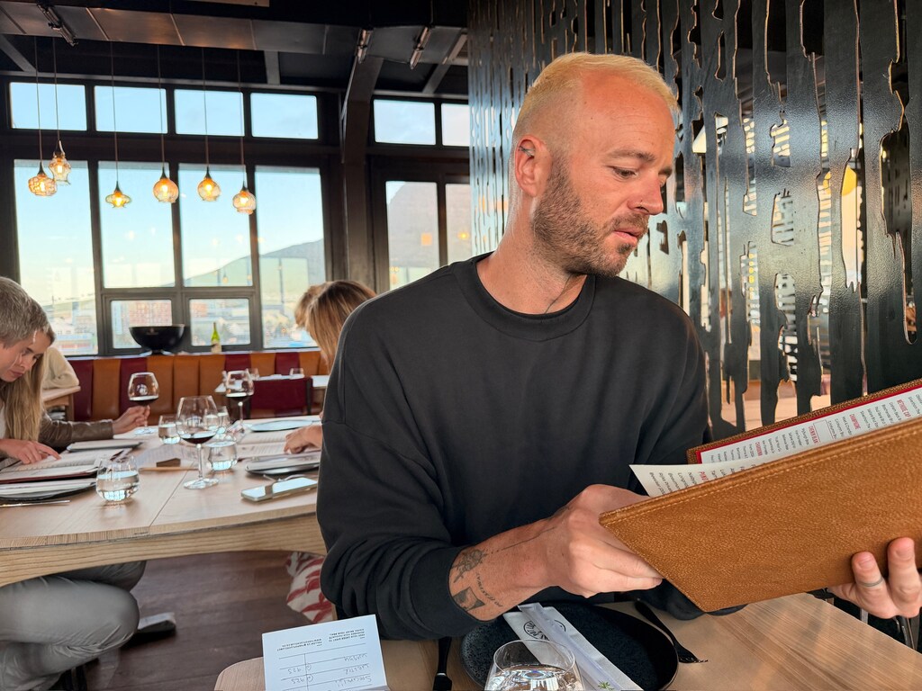Living in Cape Town with Kids – What It’s Really Like 11 A man reading the menu of a restaurant.