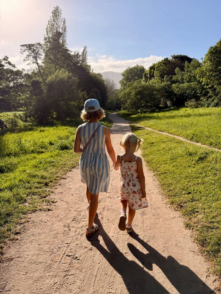Two girls walking hand in hand. Is Cape Town safe for families?