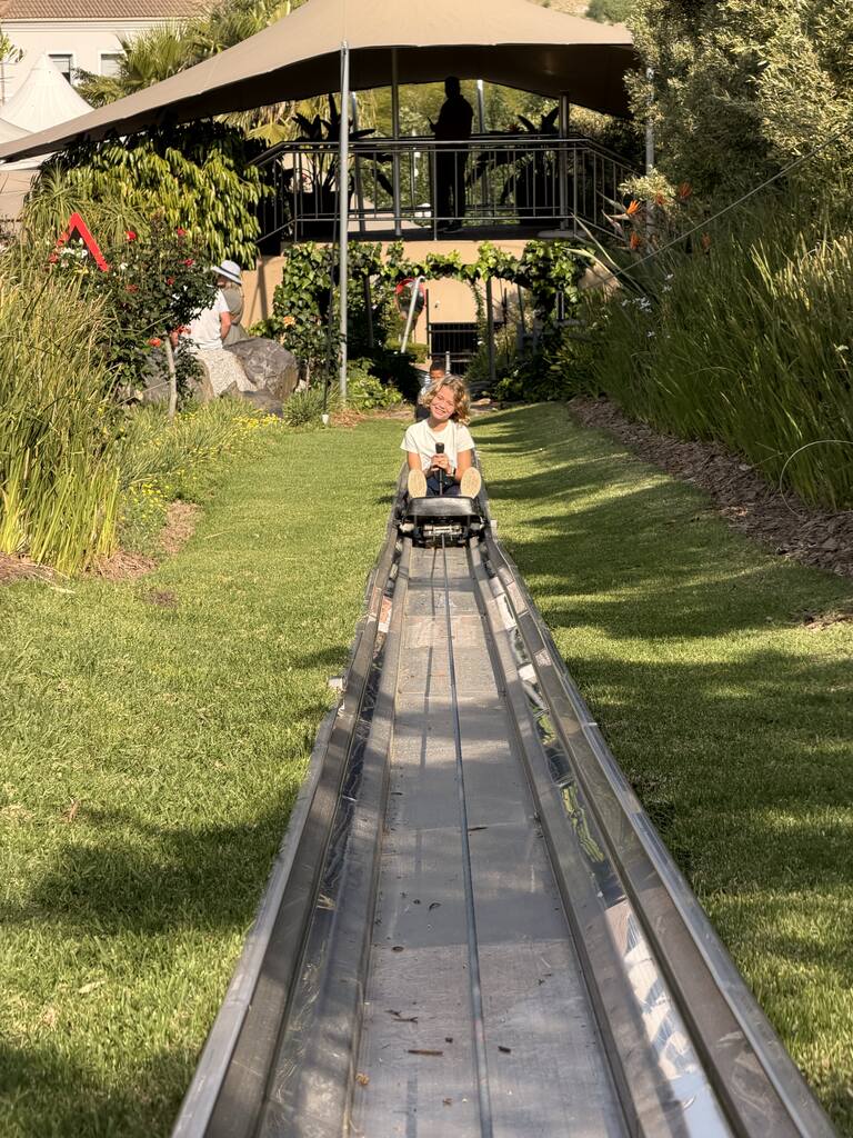Toboggan Cape Town Fun: Our Day at Cool Runnings 16 Child riding down a metal slide.