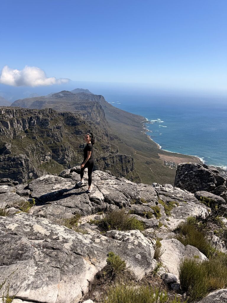 Woman enjoying view from the top of a mountain.