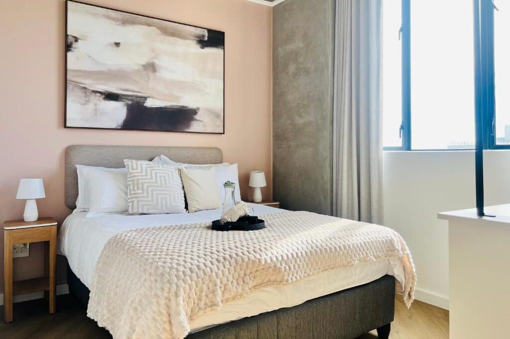 Holiday Apartment bedroom with pink wall.