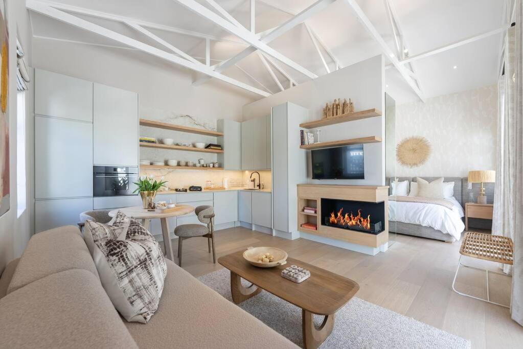 Bright living room with large sofa and fire place.